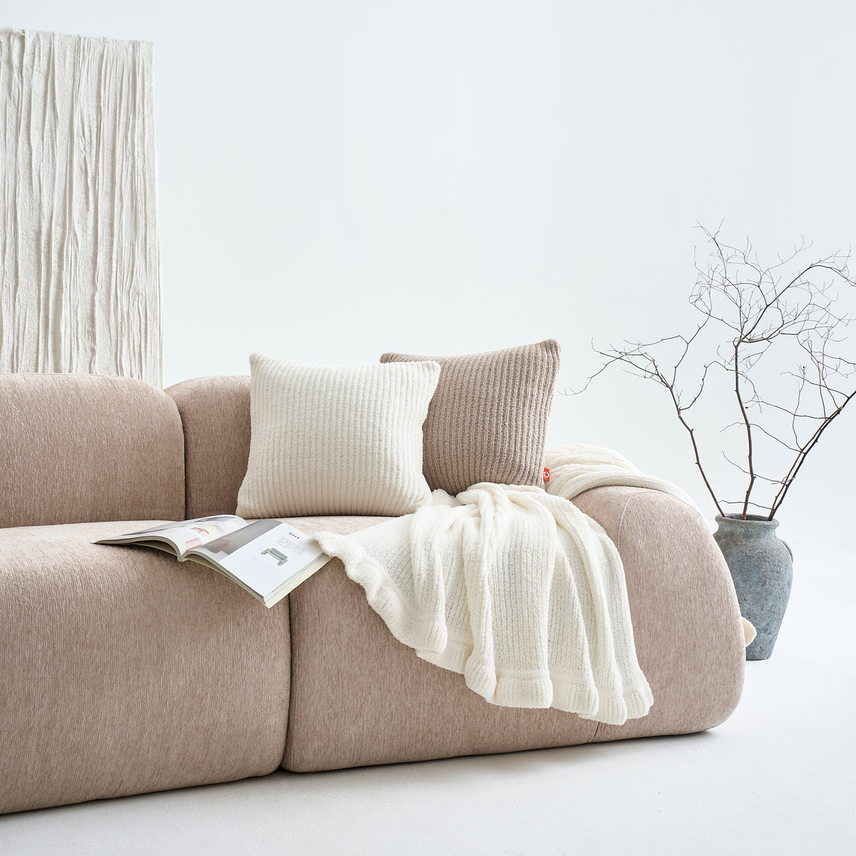 Layer it - Throw over the arm, pillow in the corner. Done.
